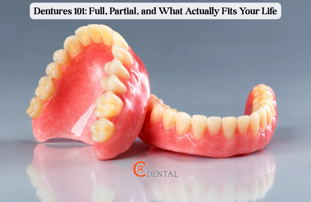 Set of full upper and lower dentures on a grey surface